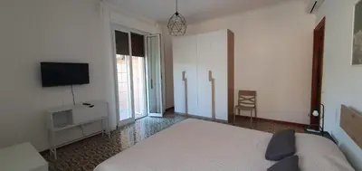 a bedroom with a bed and a flat screen tv at Attico a Gianicolense in Rome