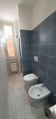 a bathroom with a toilet and a sink at Attico a Gianicolense in Rome