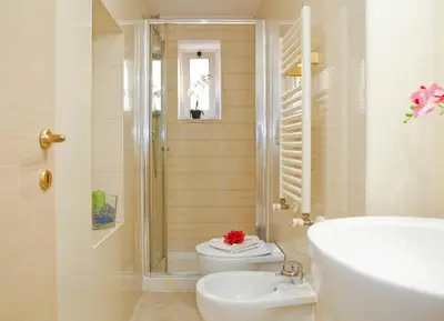 a bathroom with a shower and a toilet and a sink at Mario Suite Spagna in Rome