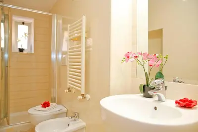 a bathroom with a sink and a toilet and a shower at Mario Suite Spagna in Rome