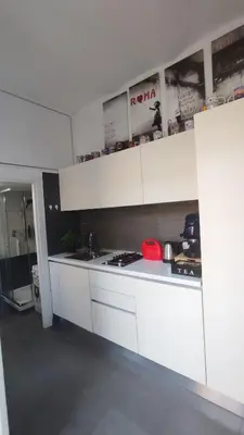 a kitchen with white cabinets and a counter top at La Dolce Vita in Rome