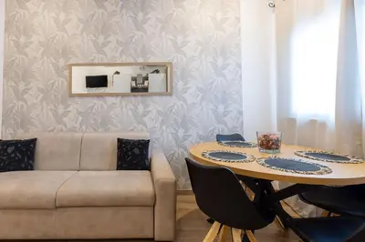 a kitchen with white cabinets and a sink at Arya Roma San Pietro in Rome