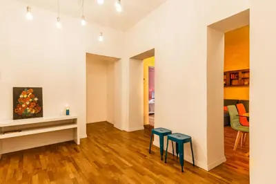 a living room with two stools and a table at Santonofrio Apartments in Rome