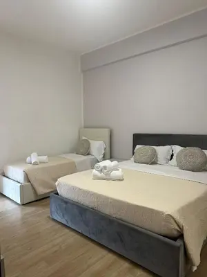 two beds sitting in a room withermottermott at La Casa Romana in Rome