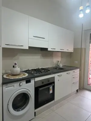 a kitchen with a stove and a washing machine at La Casa Romana in Rome
