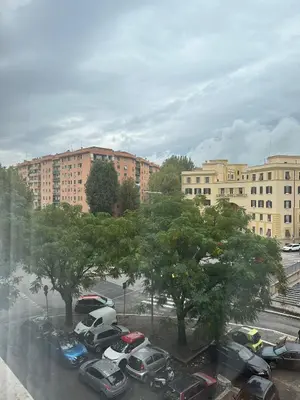 a parking lot with cars parked in front of buildings at La Casa Romana in Rome
