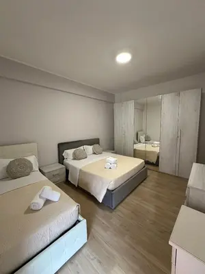 a bedroom with two beds and a mirror at La Casa Romana in Rome