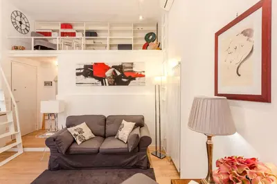 a living room with a couch and a lamp at La Casa Di Teo in Rome