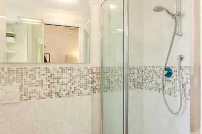 a bathroom with a shower with a glass door at La Casa Di Teo in Rome