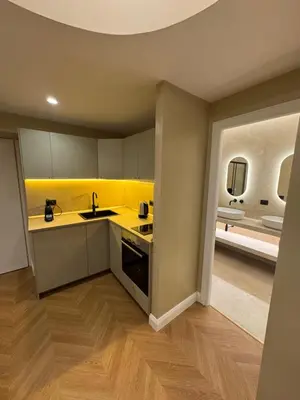a kitchen with a sink and a yellow wall at Vatican Loft - Liberty Collection in Rome