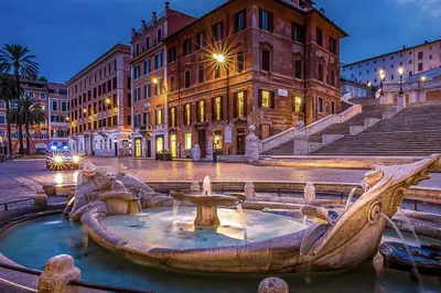 a fountain in the middle of a city at night at Vatican Loft - Liberty Collection in Rome