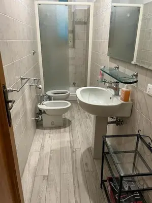 a bathroom with two sinks and a toilet in it at Domus Alexandra in Rome