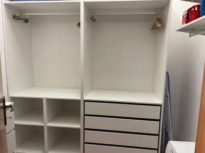 a white closet with white shelves in it at Domus Alexandra in Rome