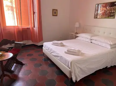 a bedroom with a bed with two white towels on it at Domus Alexandra in Rome