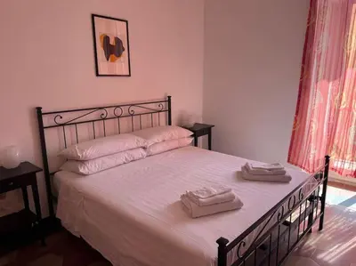 a bedroom with a bed with two towels on it at Domus Alexandra in Rome