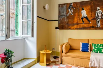 a living room with a couch and a painting on the wall at iFlat Colorful New Apartment in Esquilino in Rome