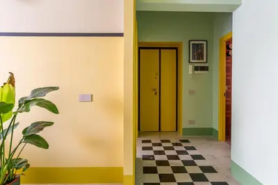 a hallway with a checkered floor and a yellow door at iFlat Colorful New Apartment in Esquilino in Rome