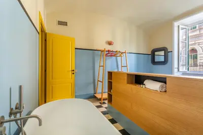 a room with a bed and a yellow door at iFlat Colorful New Apartment in Esquilino in Rome