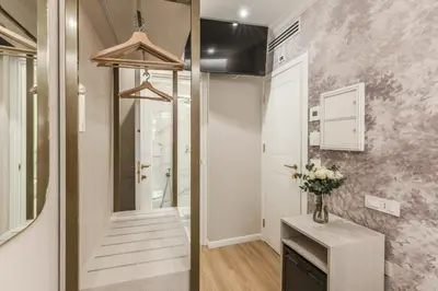 a bathroom with a staircase and a vase of flowers at Lumi Hotel in Rome