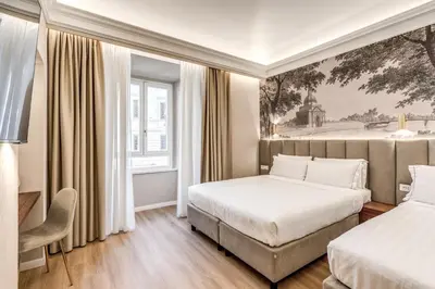 a hotel room with two beds and a window at Lumi Hotel in Rome