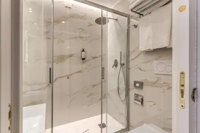 a shower with a glass door in a bathroom at Lumi Hotel in Rome