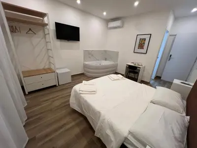 a bedroom with a white bed and a toilet at Suite 98 in Rome