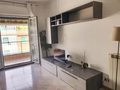 a kitchen with a counter and a large window at Erika's Apartment in Rome