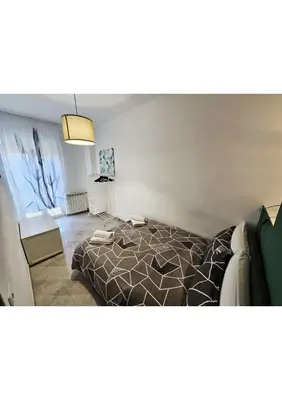 a bedroom with a bed and a living room at Erika's Apartment in Rome