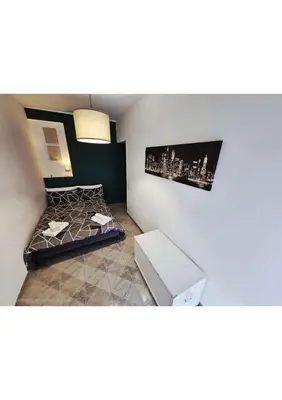 a small bedroom with a bed and a couch at Erika's Apartment in Rome