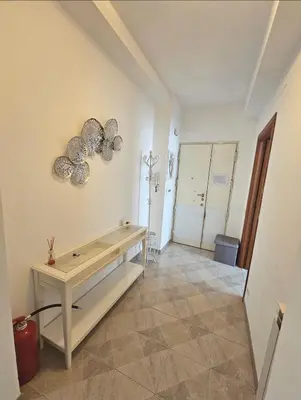 a room with a table on the wall at Erika's Apartment in Rome
