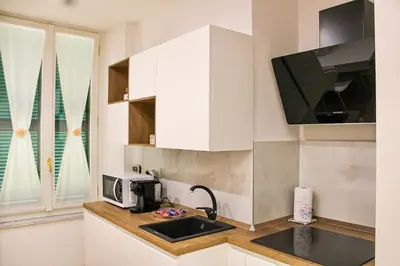 a kitchen with a sink and a microwave at Coppedè Lovely Apartment in Rome