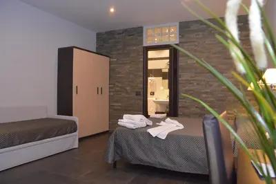 a hotel room with two beds and a mirror at Beautiful Colosseum Roma in Rome