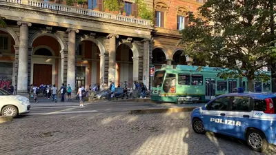 a police car and a bus on a city street at Beautiful Colosseum Roma in Rome