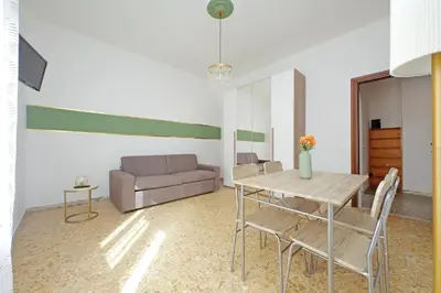 a living room with a table and a couch at Golden Apartment in Rome