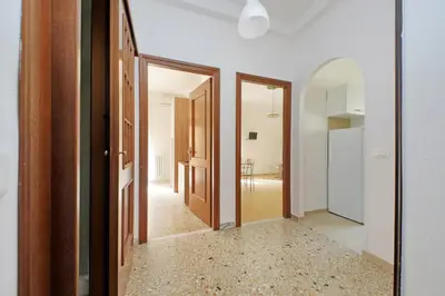 an empty hallway with two doors and a mirror at Golden Apartment in Rome