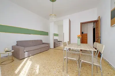 a living room with a couch and a table and chairs at Golden Apartment in Rome