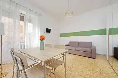 a living room with a table and a couch at Golden Apartment in Rome