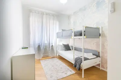 a bedroom with two bunk beds and a desk at Apartment Valle Aurelia Metro in Rome
