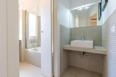 a bathroom with a sink and a mirror at Apartment Valle Aurelia Metro in Rome