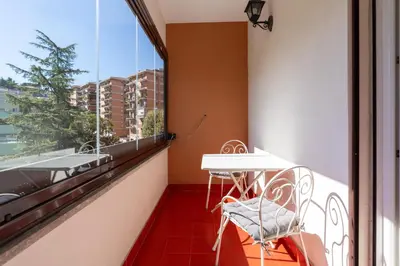 a balcony with a table and chairs and a window at Apartment Valle Aurelia Metro in Rome