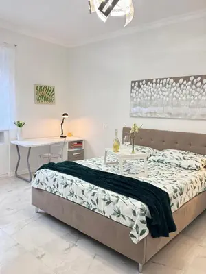 a bedroom with a bed and a table and a desk at Casa Giulia in Rome