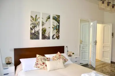 a bedroom with a bed with two paintings on the wall at Cozy hideaway in Trastevere in Rome