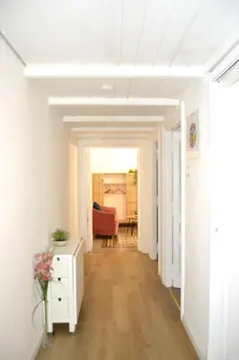 a hallway leading to a living room with white walls at Cozy hideaway in Trastevere in Rome