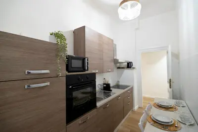 a kitchen with a microwave and a black refrigerator at Cozy hideaway in Trastevere in Rome