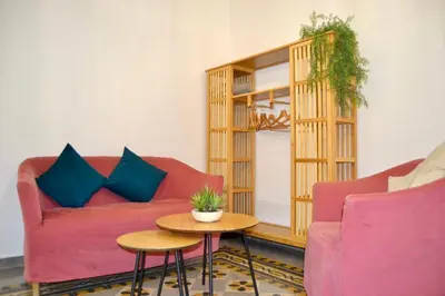 a living room with a red couch and a table at Cozy hideaway in Trastevere in Rome