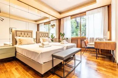 a bedroom with two beds and a desk at Appartamento 