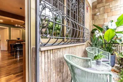 a patio with two green chairs and a table at Appartamento 