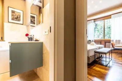 a room with a kitchen and a dining room with a table at Appartamento 