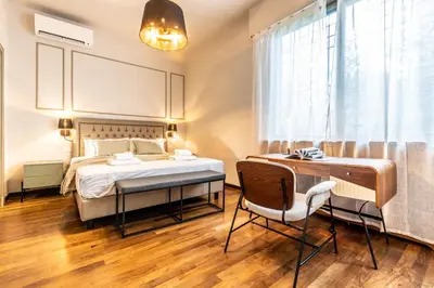 a bedroom with a bed and a desk and a window at Appartamento 