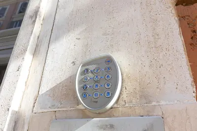 a remote control sitting on the side of a wall at San Lorenzo Style Apartment in Rome